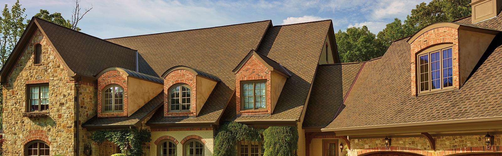 Higher-end home with a brown shingle roof